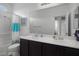 Bathroom featuring a double vanity with two sinks, neutral walls and tile flooring at 33 Via Di Mello, Henderson, NV 89011