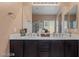 Bathroom featuring a double vanity with two sinks, neutral walls and tile flooring at 33 Via Di Mello, Henderson, NV 89011
