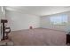 Spacious bonus room with neutral carpet, white walls and a large window at 33 Via Di Mello, Henderson, NV 89011