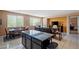 Open concept living room and dining area with tile floors and large island at 33 Via Di Mello, Henderson, NV 89011