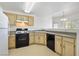 Functional kitchen layout featuring white appliances and light wood cabinets, ready for updates at 3400 Cabana Dr # 2103, Las Vegas, NV 89122