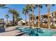 Relaxing community pool with tropical palm trees and lounge area for residents at 3400 Cabana Dr # 2103, Las Vegas, NV 89122