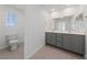 Bright bathroom with a double vanity, tile flooring, and mirror at 3541 Arcadian Sea St, Las Vegas, NV 89106