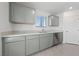 Modern kitchen featuring sleek gray cabinets, stainless steel appliances, and quartz countertops at 3541 Arcadian Sea St, Las Vegas, NV 89106