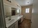 Bright bathroom with dual sinks, a large mirror, and tile flooring at 4064 Browndeer Cir, Las Vegas, NV 89129