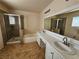 Bathroom featuring double sinks, a large mirror, a tub, and a separate shower at 4064 Browndeer Cir, Las Vegas, NV 89129