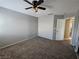 A spacious bedroom with neutral carpet and a ceiling fan providing a comfortable atmosphere at 4064 Browndeer Cir, Las Vegas, NV 89129