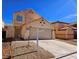 Two-story home featuring a two-car garage, rock landscaping, and neutral color palette in a well-maintained neighborhood at 4064 Browndeer Cir, Las Vegas, NV 89129