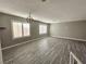 Spacious living room with hardwood floors and large windows providing ample natural light at 4064 Browndeer Cir, Las Vegas, NV 89129