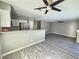 Open concept living room and kitchen with stainless appliances and modern ceiling fans at 4064 Browndeer Cir, Las Vegas, NV 89129