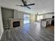 Bright living room featuring a fireplace, sliding door to the yard and modern ceiling fan at 4064 Browndeer Cir, Las Vegas, NV 89129