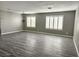 Spacious living room featuring neutral paint, wood-look flooring, and modern window shutters at 4064 Browndeer Cir, Las Vegas, NV 89129