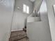 Carpeted stairway with bright window and a decorative vase on the landing at 4064 Browndeer Cir, Las Vegas, NV 89129