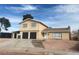 Two-story home with a two-car garage, desert landscaping and stairs leading to the front door at 4300 Don Quixote St, Las Vegas, NV 89121