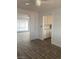Tile flooring leads to a bright room with white cabinets and another large room with window coverings at 4300 Don Quixote St, Las Vegas, NV 89121