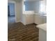 Clean kitchen featuring a window above the sink, white cabinets, solid countertops, and tile flooring at 4300 Don Quixote St, Las Vegas, NV 89121
