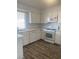 Bright kitchen featuring white cabinets, stainless steel appliances, tile flooring, and a sunlit window at 4300 Don Quixote St, Las Vegas, NV 89121