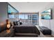 Bedroom features a comfy gray bed with a bench and views of the city outside the window at 4471 Dean Martin Dr # 2605, Las Vegas, NV 89103