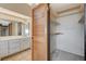 Bathroom with large mirrored closet, white vanity and tiled floors at 4706 Obannon Dr # C, Las Vegas, NV 89102