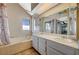Bathroom with double sinks, bathtub, and natural lighting at 4706 Obannon Dr # C, Las Vegas, NV 89102