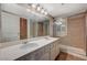 Well-lit bathroom featuring dual sinks, a spacious shower, and tiled floors at 4706 Obannon Dr # C, Las Vegas, NV 89102