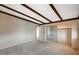 Spacious bedroom featuring a beamed ceiling, large mirrored closet, and neutral carpeting at 4706 Obannon Dr # C, Las Vegas, NV 89102