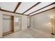 Comfortable bedroom features a closet with mirrored doors, carpet floors, and beamed ceilings at 4706 Obannon Dr # C, Las Vegas, NV 89102