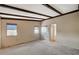 Spacious bedroom showcasing carpet floors, neutral walls, and beamed ceilings at 4706 Obannon Dr # C, Las Vegas, NV 89102