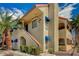 Attractive condo exterior with stairs leading to the second level and blue awnings at 4706 Obannon Dr # C, Las Vegas, NV 89102
