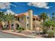 Inviting two-story condo with desert landscaping, palm trees, and red tile roof at 4706 Obannon Dr # C, Las Vegas, NV 89102