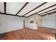 Spacious living room with ceiling fan, wood floors, and partial view of kitchen at 4706 Obannon Dr # C, Las Vegas, NV 89102
