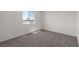 Sunlit carpeted bedroom with a view and fresh, neutral palette at 4916 Canna Lily St, Las Vegas, NV 89122