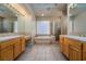 Luxurious bathroom with dual vanities, a soaking tub, and a separate glass-enclosed shower for ultimate relaxation at 504 Pinnacle Heights Ln, Las Vegas, NV 89144