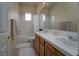 Well-lit bathroom featuring a double vanity and a shower-tub combination at 504 Pinnacle Heights Ln, Las Vegas, NV 89144