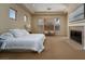 Serene bedroom featuring a fireplace, plush carpet, and ample natural light creating a relaxing retreat at 504 Pinnacle Heights Ln, Las Vegas, NV 89144