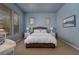 Serene bedroom with natural light, soft blue walls, and a comfortable wicker bed at 504 Pinnacle Heights Ln, Las Vegas, NV 89144