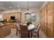 Charming dining area with a round table, comfortable seating, and views of the landscaped backyard at 504 Pinnacle Heights Ln, Las Vegas, NV 89144