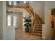 Stairway in the foyer featuring a curved staircase, elegant railings, and natural light from the front doors at 504 Pinnacle Heights Ln, Las Vegas, NV 89144