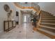 Grand foyer with a winding staircase, tile flooring, and elegant decor creating a welcoming entrance at 504 Pinnacle Heights Ln, Las Vegas, NV 89144