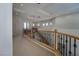 Upstairs hallway with decorative wrought iron railing, recessed lights, and coffered ceiling at 504 Pinnacle Heights Ln, Las Vegas, NV 89144