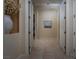Hallway with neutral walls, tiled floors, and multiple doorways offering access to different rooms in the home at 504 Pinnacle Heights Ln, Las Vegas, NV 89144