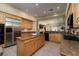 Spacious kitchen featuring wood cabinetry, stainless steel appliances, and a large center island at 504 Pinnacle Heights Ln, Las Vegas, NV 89144