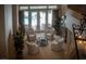 Elegant sitting area with four chairs, round glass table, and direct view and access to the outdoor pool at 504 Pinnacle Heights Ln, Las Vegas, NV 89144