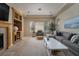 Bright living room with large windows, neutral color palette, and stylish furnishings and entertainment center at 504 Pinnacle Heights Ln, Las Vegas, NV 89144