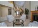 Cozy living room with a fireplace, staircase, and comfortable seating area at 504 Pinnacle Heights Ln, Las Vegas, NV 89144