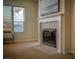 Inviting living room featuring a fireplace, large window for natural light, and neutral carpet flooring at 504 Pinnacle Heights Ln, Las Vegas, NV 89144
