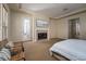 Comfortable primary bedroom with a fireplace, sitting area, and view into the bathroom and hallway at 504 Pinnacle Heights Ln, Las Vegas, NV 89144