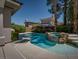 Beautiful backyard pool features a rock waterfall and lush landscaping, creating a private oasis at 504 Pinnacle Heights Ln, Las Vegas, NV 89144