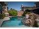 The backyard features a rock waterfall, providing a relaxing ambiance for swimming at 504 Pinnacle Heights Ln, Las Vegas, NV 89144