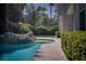 Beautiful backyard pool features a rock waterfall and lush landscaping, creating a private oasis at 504 Pinnacle Heights Ln, Las Vegas, NV 89144
